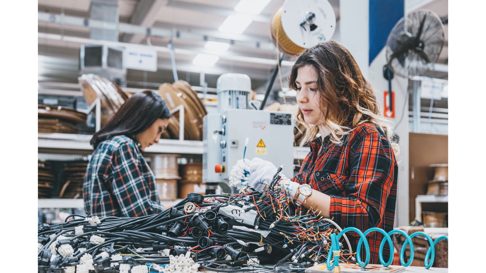Women With STEAM: Amplifying Women in STEM - Rock the STEAM Team Inc. Two women work on cabling in a workshop