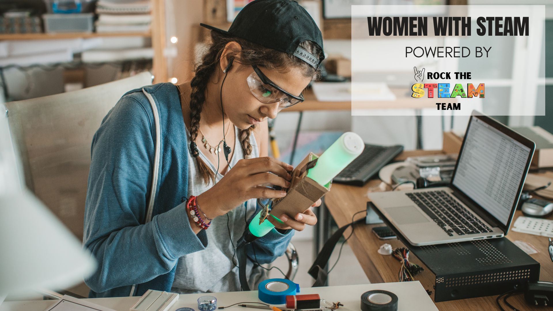 a woman tinkers with a project while sitting in front of an open laptop
