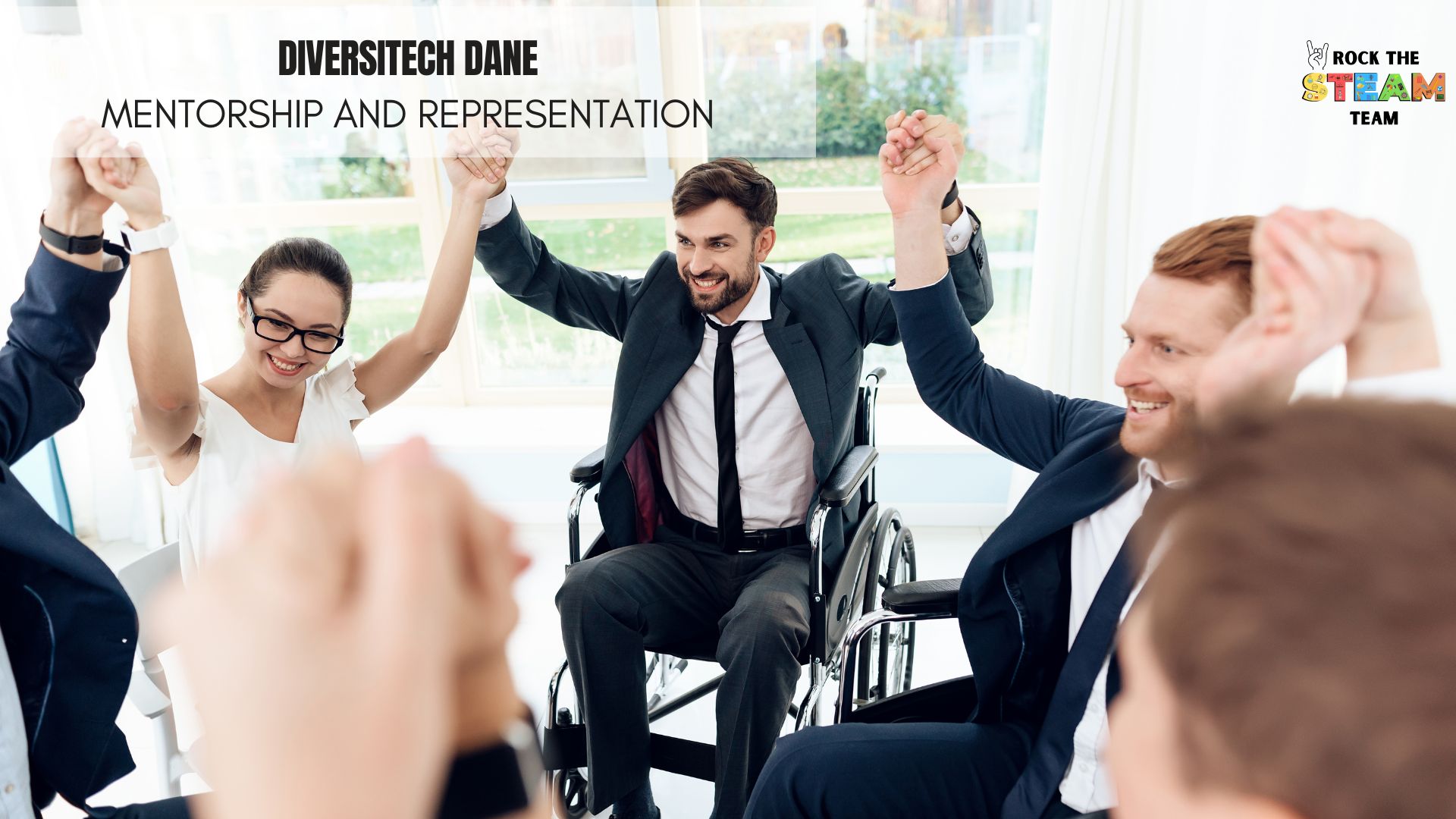 DiversiTECH Dane - Rock the STEAM Team Inc. a group of business people in a meeting room with their hands in the air
