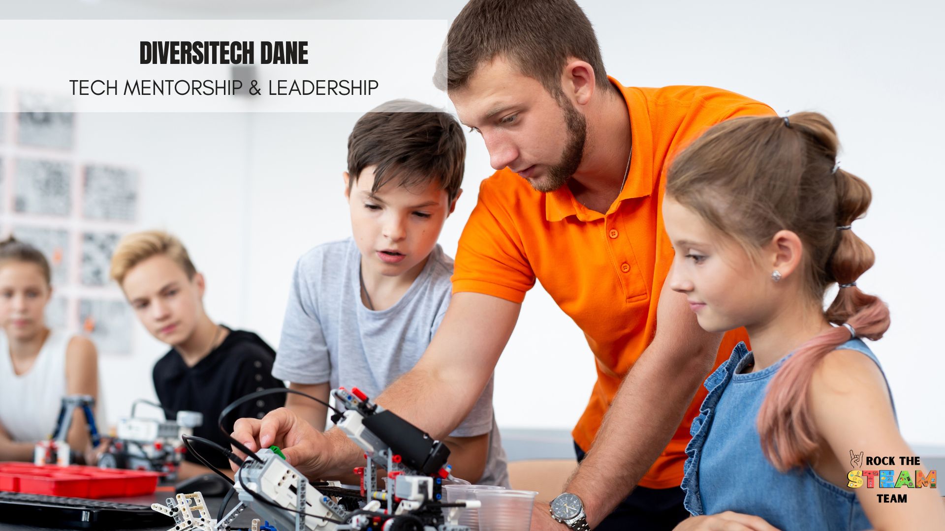 DiversiTECH Dane - Rock the STEAM Team Inc. a group of children and a man working on a robot